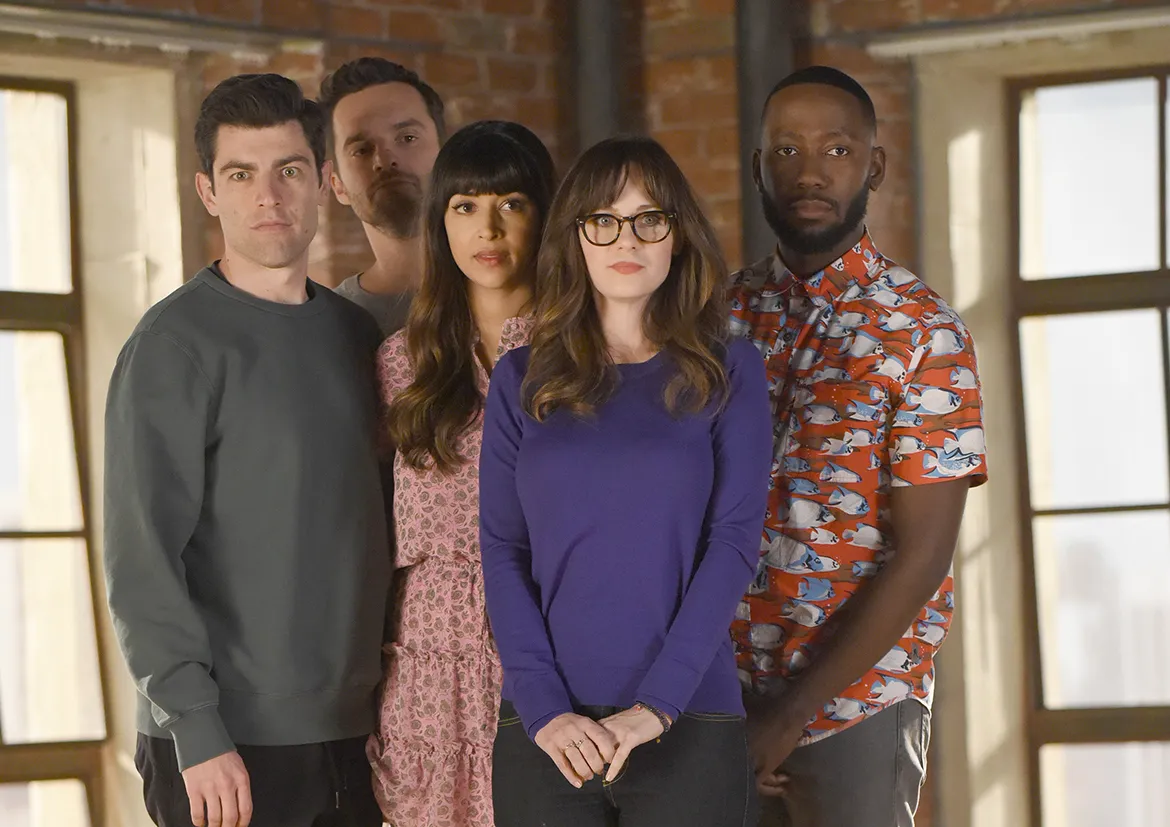 The cast of New Girl smiling together.