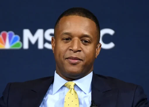 Craig Melvin sits at the Today show desk, looking serious and calm while reporting.