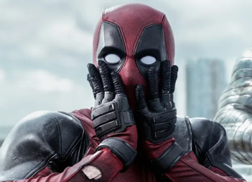 Ryan Reynolds as Deadpool in his iconic red and black suit, looking ready for action.