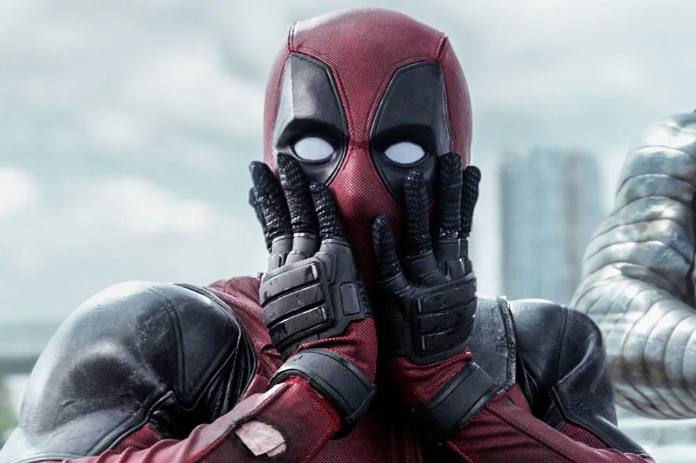 Ryan Reynolds as Deadpool in his iconic red and black suit, looking ready for action.