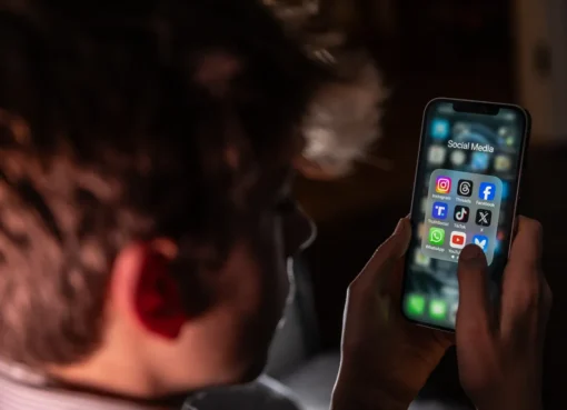 A smartphone screen showing social media apps fading out at midnight, with a digital clock striking 12.