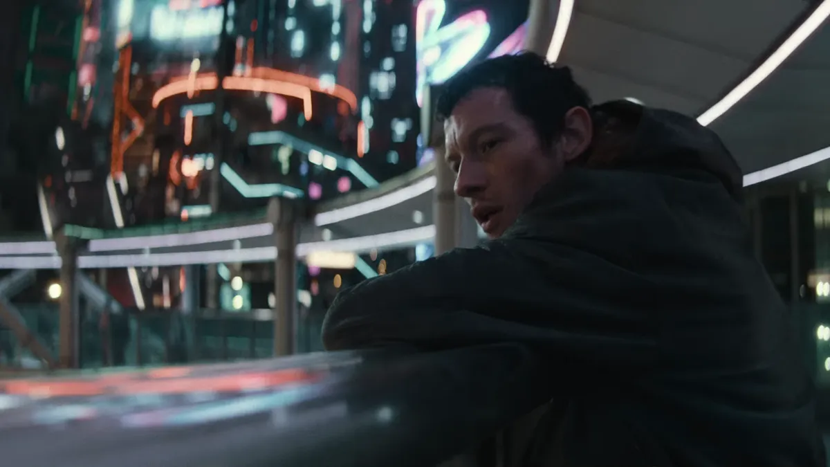 Callum Turner appearing on screen at Comic-Con.