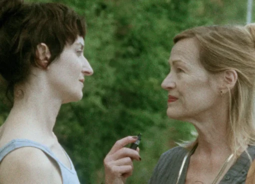 Photo of director Denis Côté with actor Larissa Corriveau, possibly on a film set.