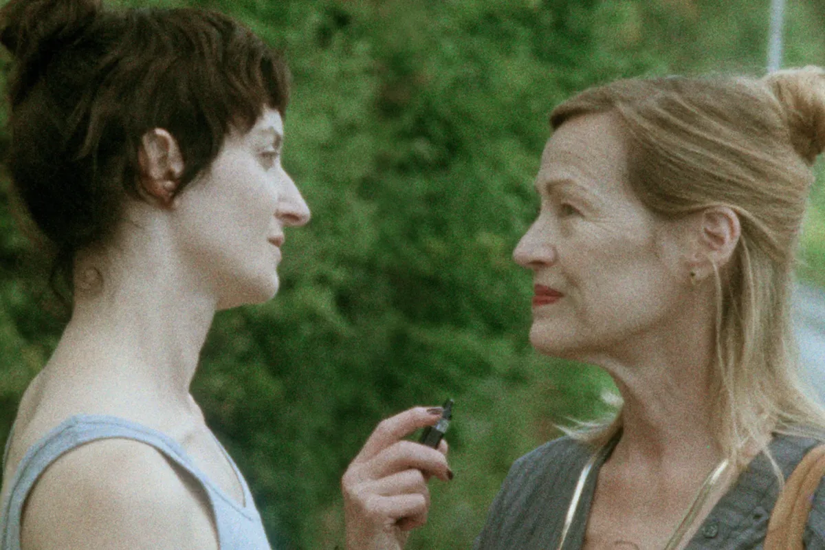 Photo of director Denis Côté with actor Larissa Corriveau, possibly on a film set.