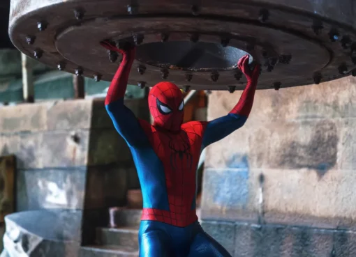 Close-up of Spider-Man's masked face with a city background, looking like a movie still.