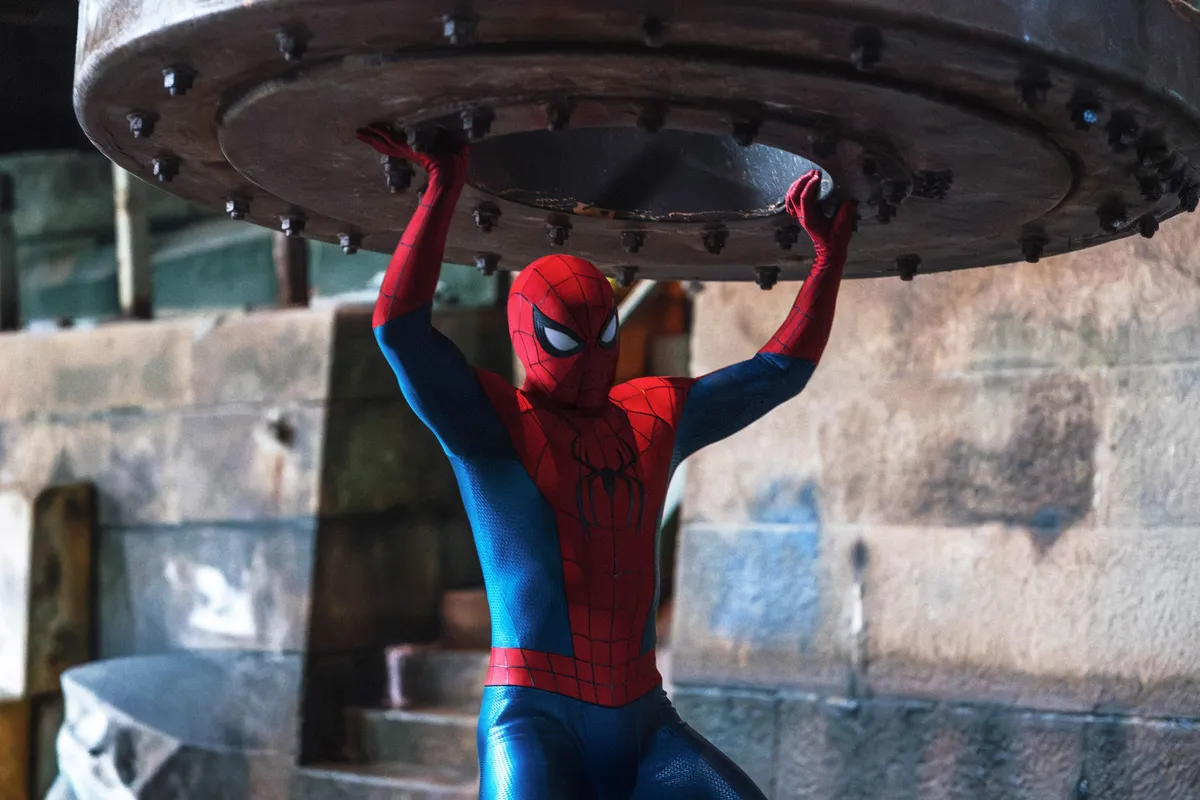 Close-up of Spider-Man's masked face with a city background, looking like a movie still.
