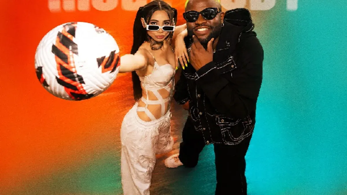 Zahrah Khan, Skales, and Sanjoy together, smiling and looking energetic, with a subtle football theme in the background.