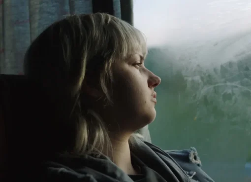 A still from the movie '17', showing a serious young woman, Sara (Eva Kostić), looking withdrawn.
