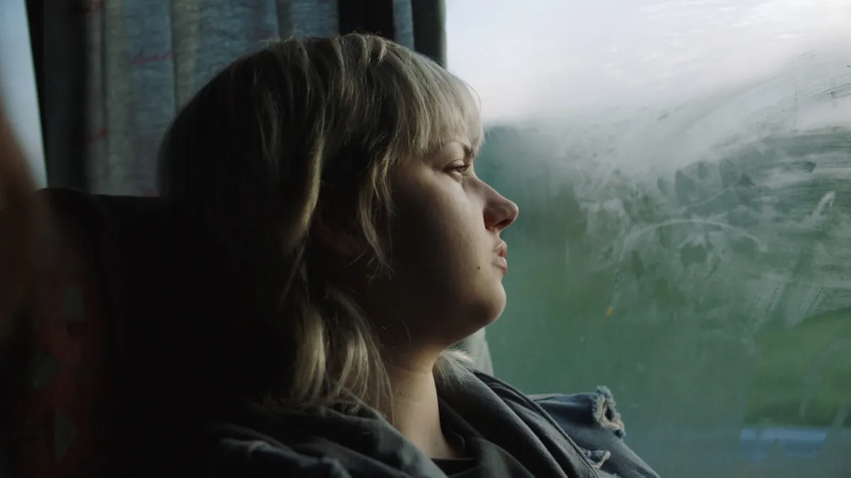 A still from the movie '17', showing a serious young woman, Sara (Eva Kostić), looking withdrawn.