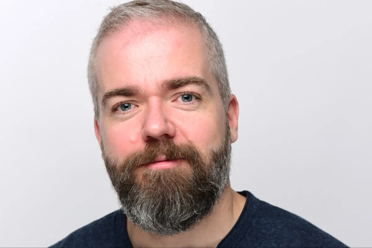 David F. Sandberg smiling on a film set.