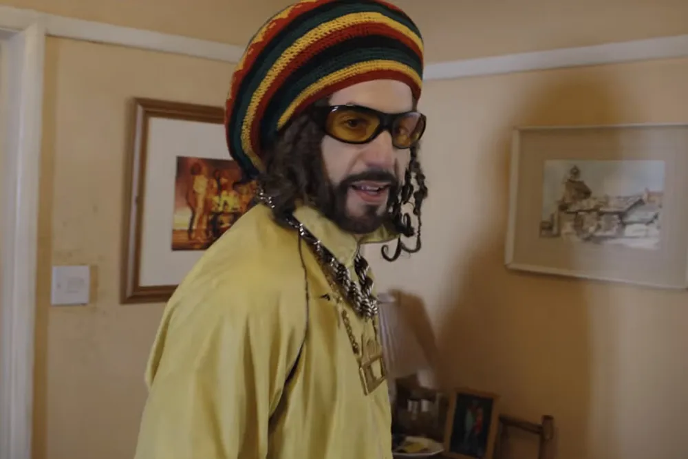 Sacha Baron Cohen as Ali G looking surprised and a bit clueless in the 'Ali G: Who Iz I?' trailer.