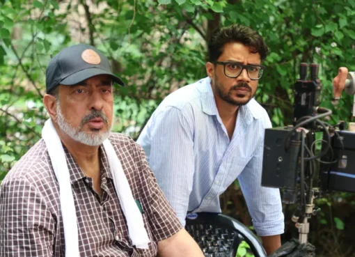 Anup Singh, director of 'Qissa,' filming a scene on the rainy streets of Mumbai.