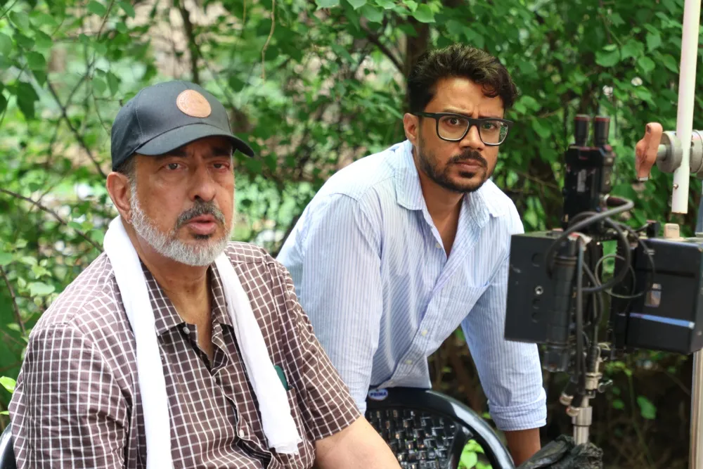 Anup Singh, director of 'Qissa,' filming a scene on the rainy streets of Mumbai.