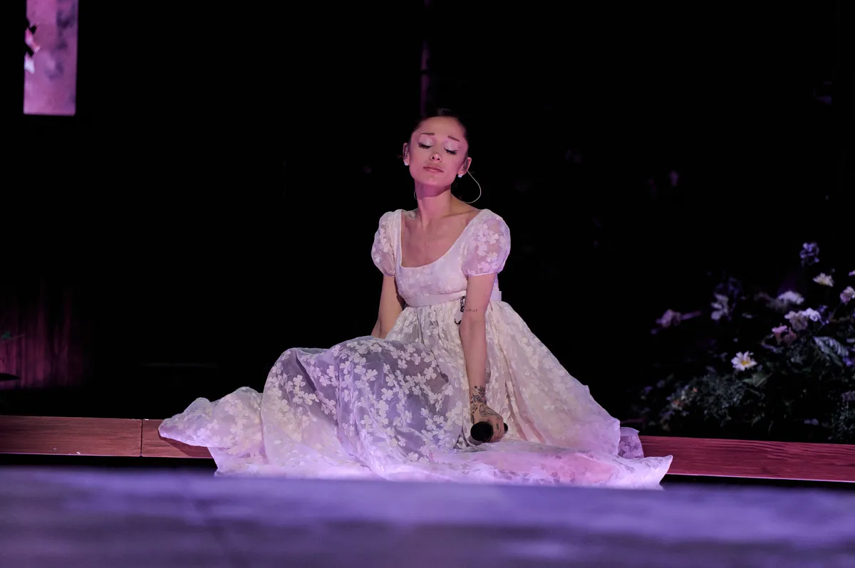 Pop star Ariana Grande smiling on stage.