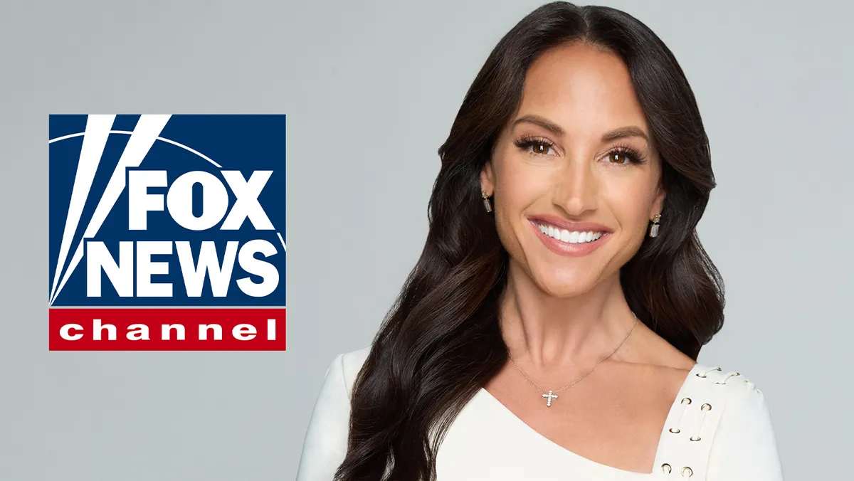 Emily Compagno smiling on a news set.