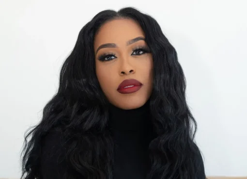 DomiNque Perry smiling brightly, radiating confidence.