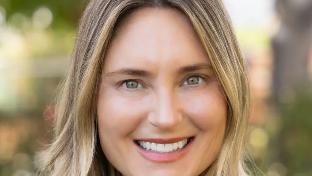 Melissa Stone smiling, a professional headshot against a bright, modern background, with a hint of Disney's creative energy.