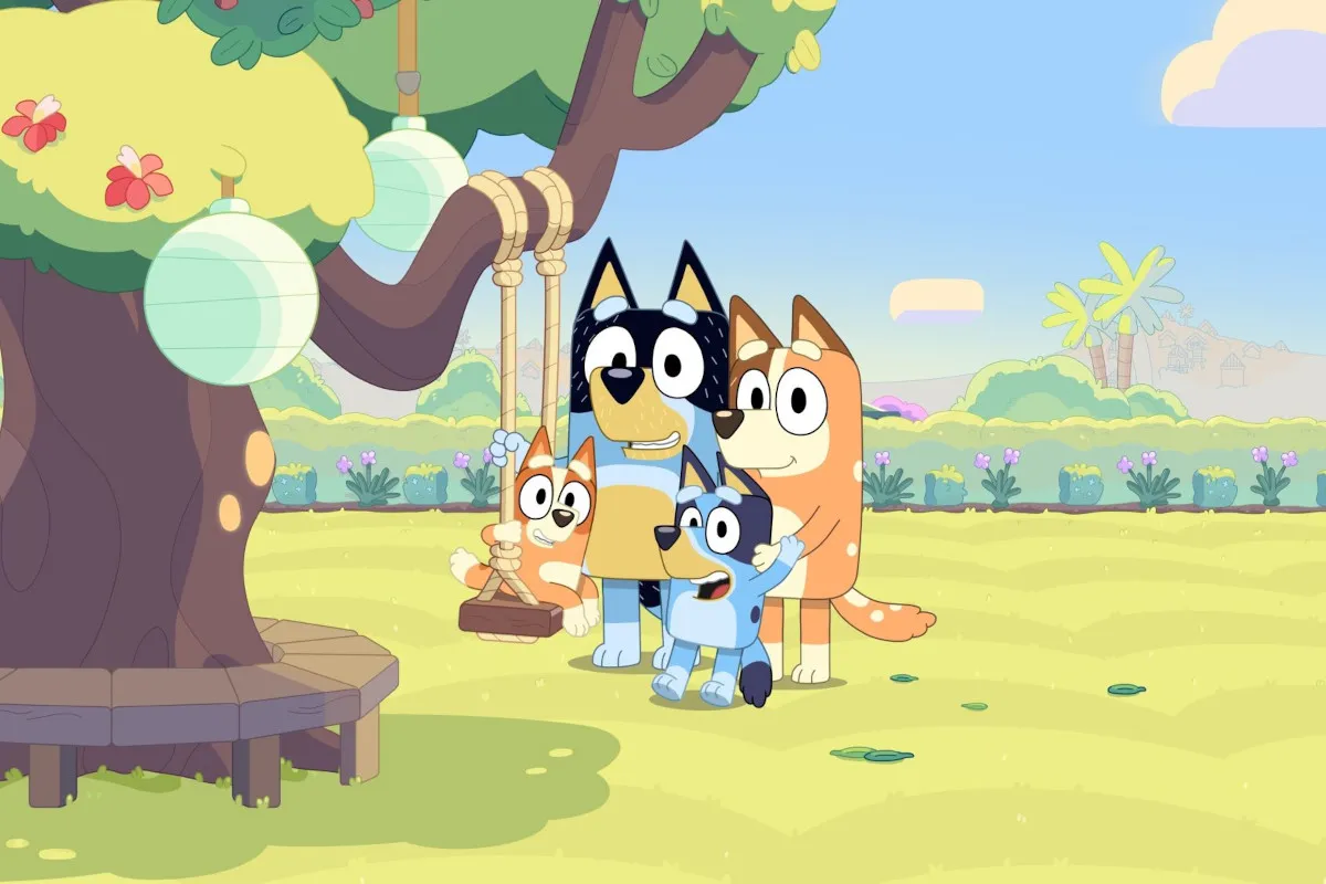 An illustration of Bluey and Bingo smiling, with Australian landmarks faintly visible in the background.