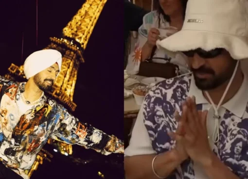 Diljit Dosanjh smiling while dipping a croissant into a cup of hot chocolate at a cafe in Paris.