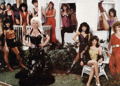 Dolly Parton smiling in a movie still.