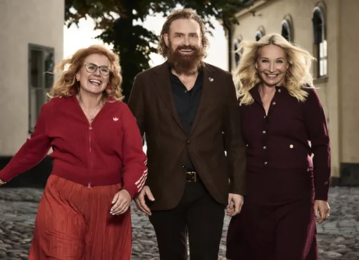 Kristofer Hivju, known for Game of Thrones, smiling brightly with his signature red beard, possibly in a warm, friendly setting.