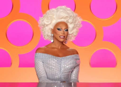 A drag queen with a dramatic makeup look and a sparkly outfit.