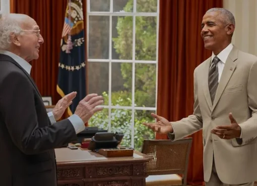 Larry David looking surprised next to a smiling Barack Obama