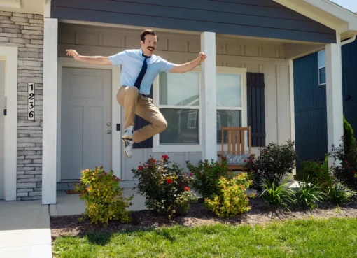 Jason Sudeikis smiling in character as Ted Lasso.