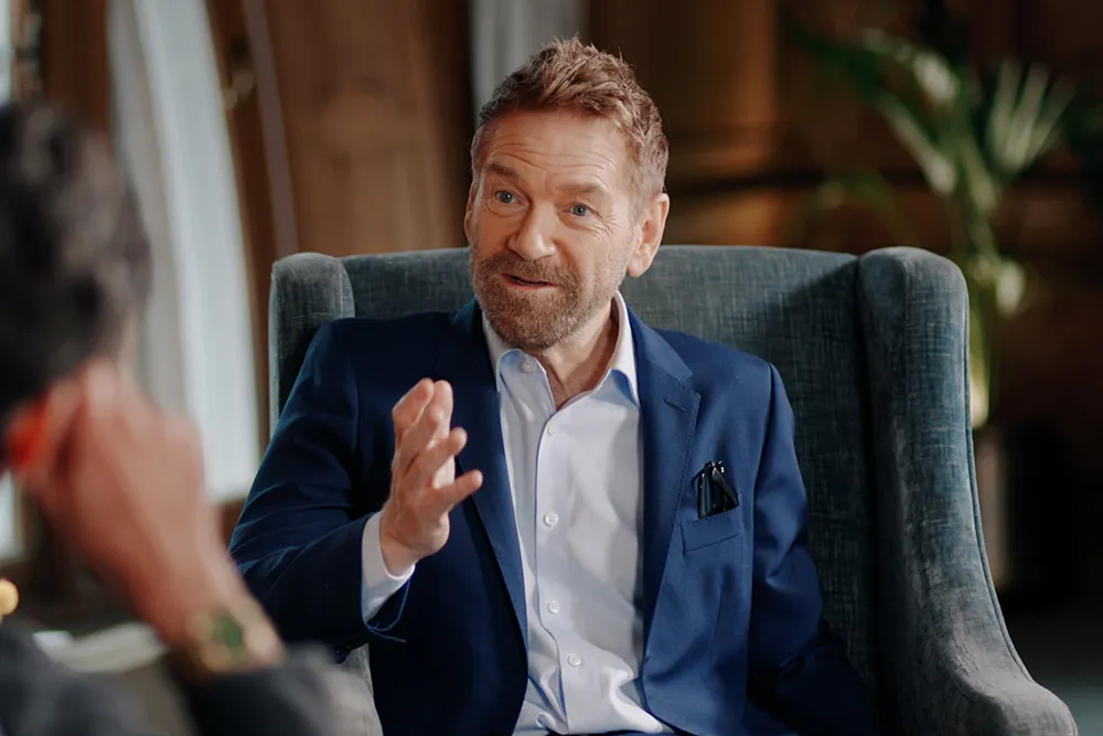 Kenneth Branagh with a determined expression, possibly in a still from an action scene, looking intense.