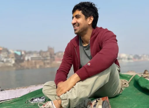 Ayan Mukerji smiling, perhaps on a film set, looking thoughtful.