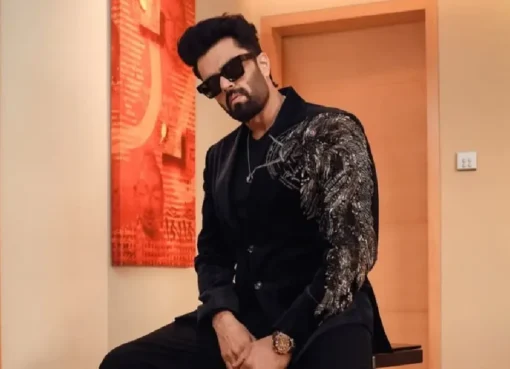 Maniesh Paul smiling, looking sharp in a stylish suit, celebrating his diverse career.