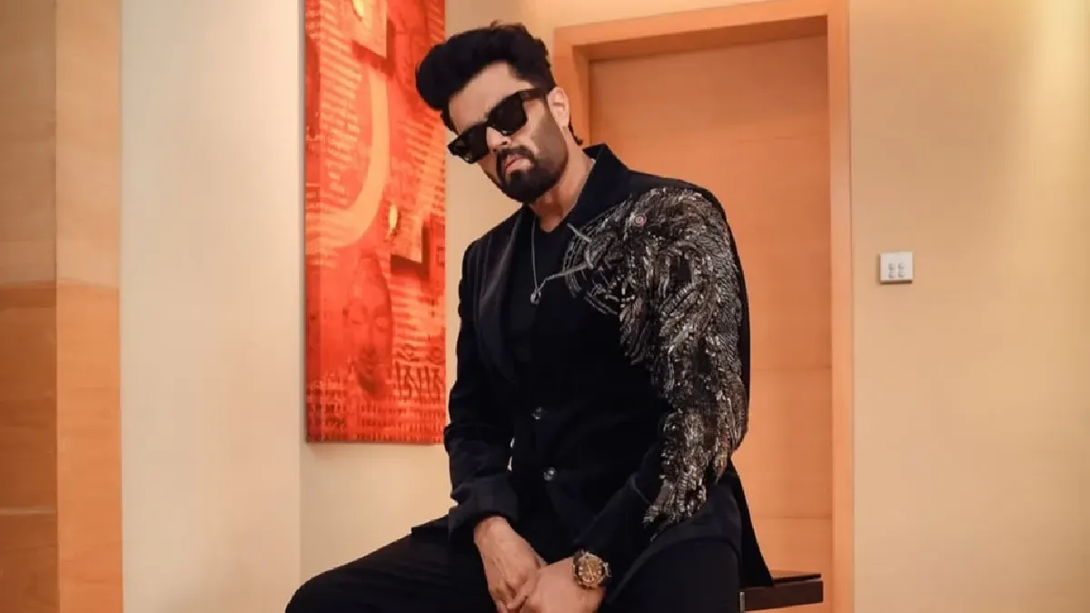Maniesh Paul smiling, looking sharp in a stylish suit, celebrating his diverse career.
