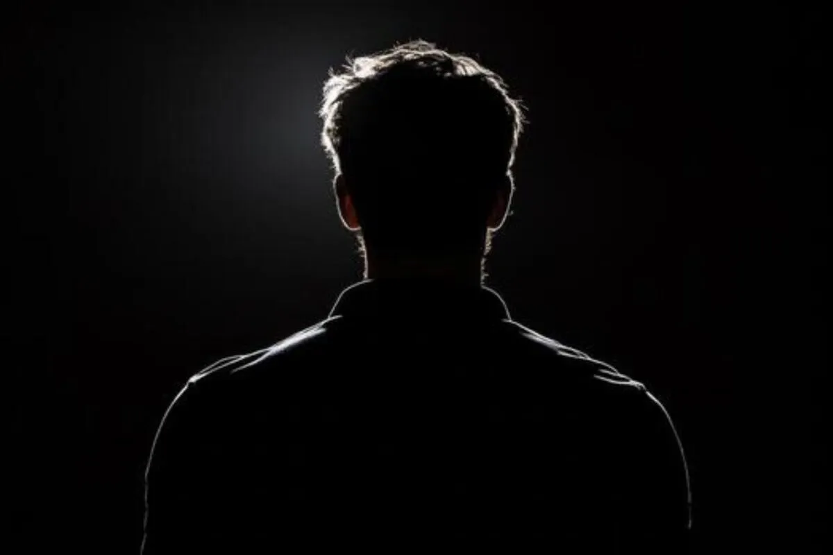 An A-list actor with a mysterious expression holding a teddy bear, set against a dark, moonlit background.
