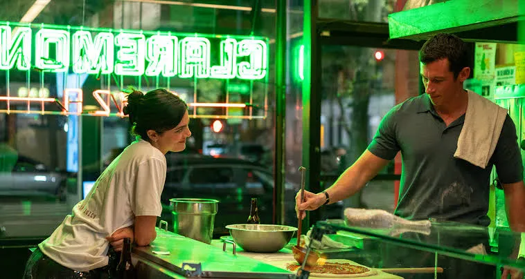Monica Barbaro and Callum Turner looking attractive in a movie scene.