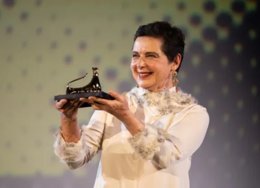 Isabella Rossellini smiling and posing elegantly at an awards ceremony.