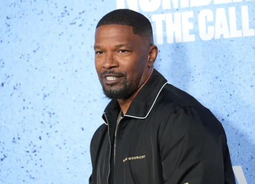 Jamie Foxx smiling at a red carpet event for a new movie.