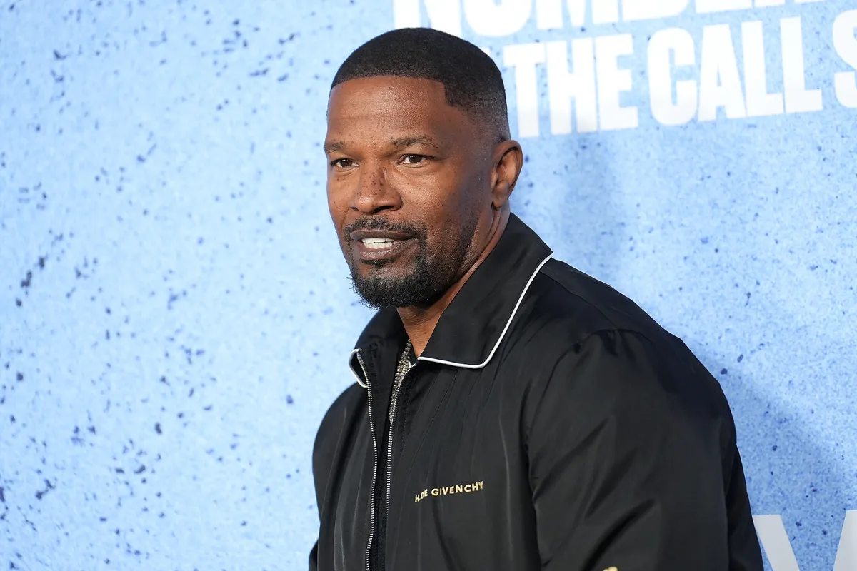 Jamie Foxx smiling at a red carpet event for a new movie.