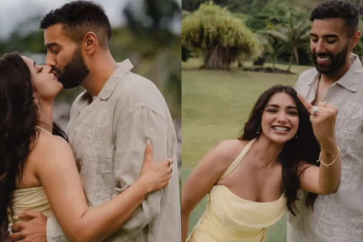 Jiya Shankar and her fiancé Kaaran kissing in a garden overlooking the ocean