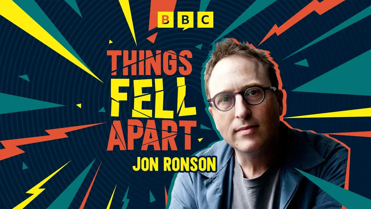 Jon Ronson smiling with a microphone, ready to tell an engaging story.