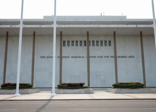 A grand, iconic shot of the Kennedy Center building against a blue sky.