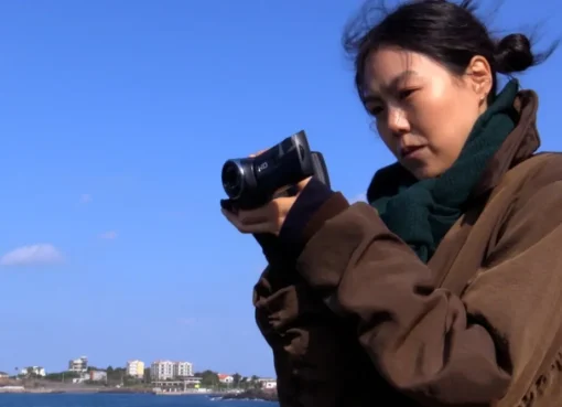 Kim Minhee looking thoughtful in a scene from 'Nowhere to Lay My Eyes'.