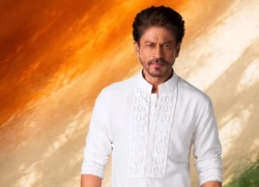 Shah Rukh Khan smiling, with a subtle patriotic background.