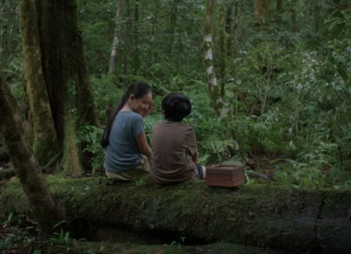 A quiet, reflective scene from Lê Bảo's film 'Hearing' showing an extended family gathered.