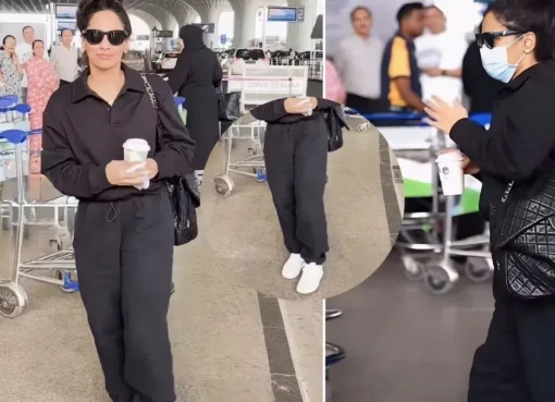 Masaba Gupta in an all-black outfit, holding a black Chanel bag, walking through an airport.
