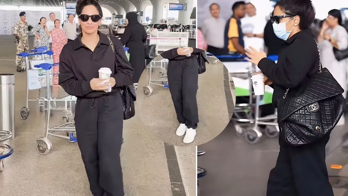 Masaba Gupta in an all-black outfit, holding a black Chanel bag, walking through an airport.
