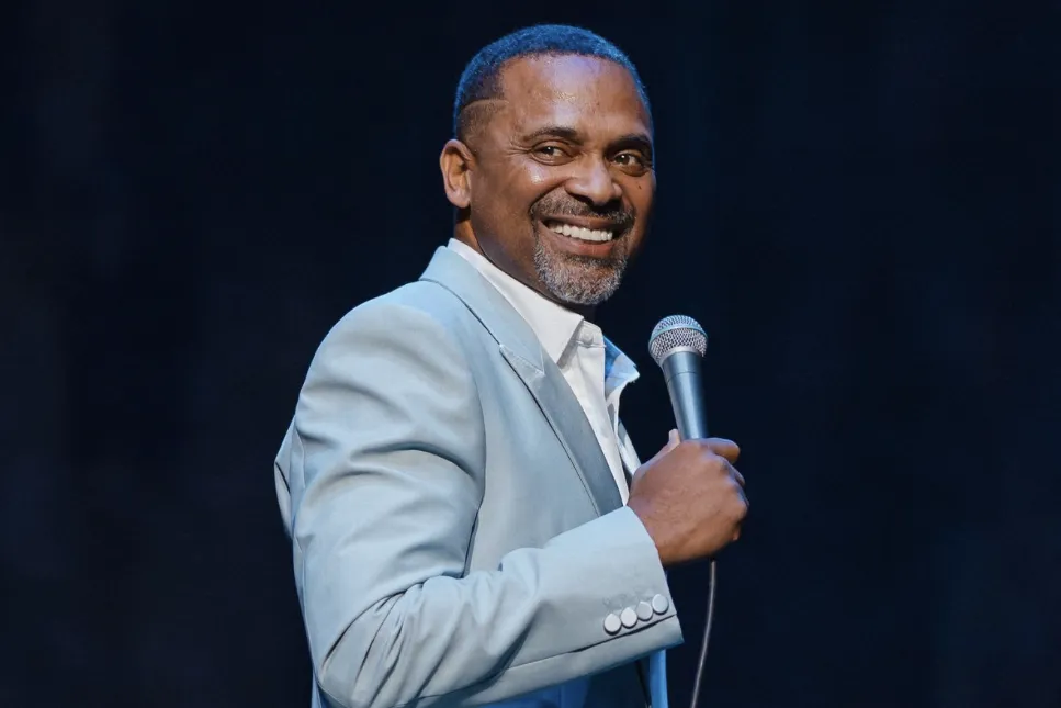 Comedian Mike Epps smiling on stage.