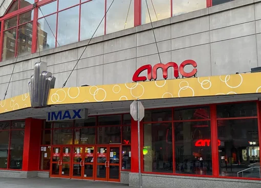 Exterior view of AMC Kips Bay 15 movie theater at dusk.