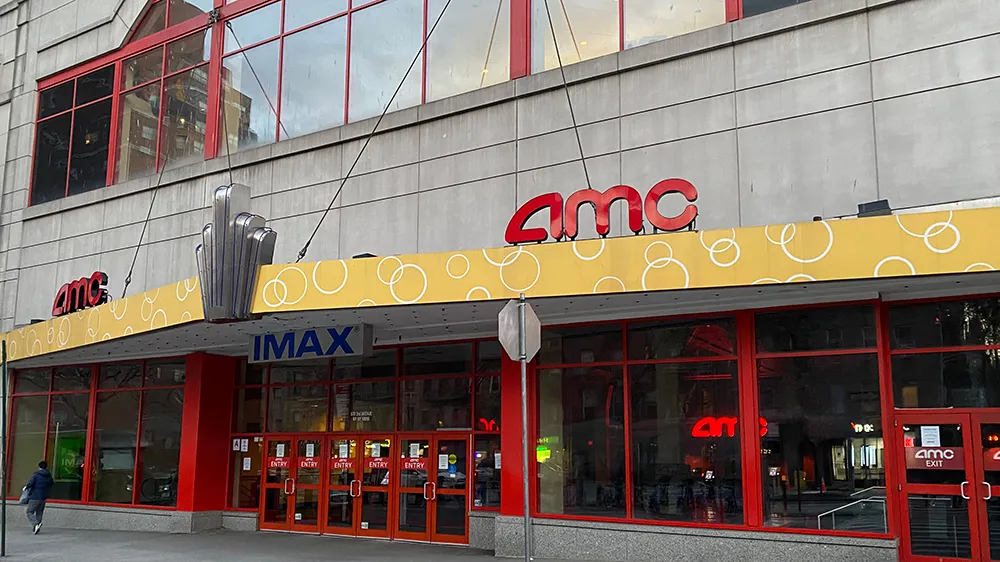 Exterior view of AMC Kips Bay 15 movie theater at dusk.