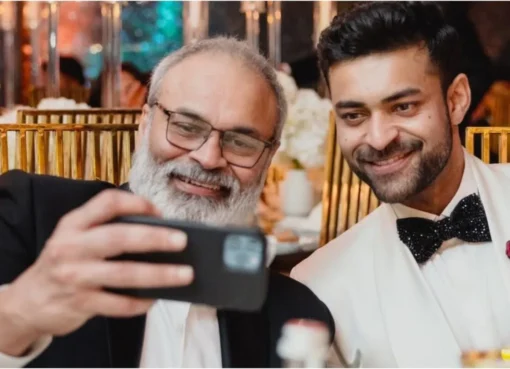 Naga Babu and Varun Tej smiling happily together.