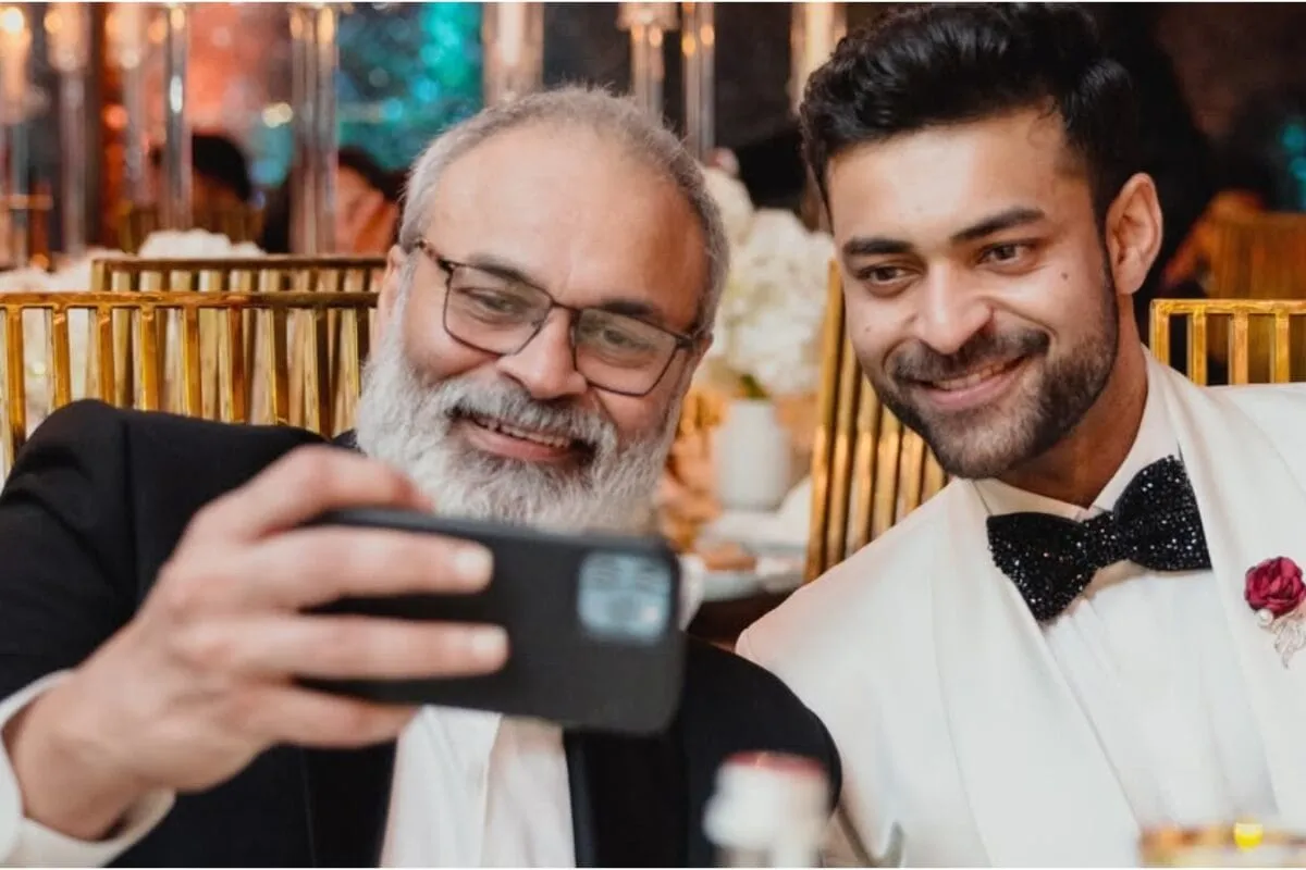 Naga Babu and Varun Tej smiling happily together.